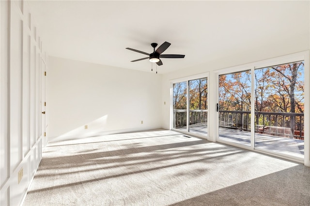 carpeted empty room with ceiling fan