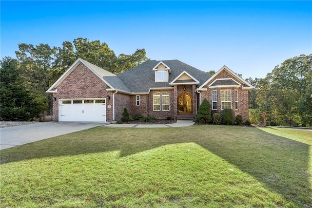 view of front of home with a front yard and a garage