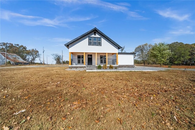 view of front of home with covered porch and a front yard