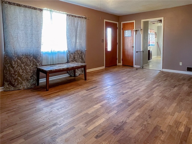 entryway with ceiling fan and wood-type flooring