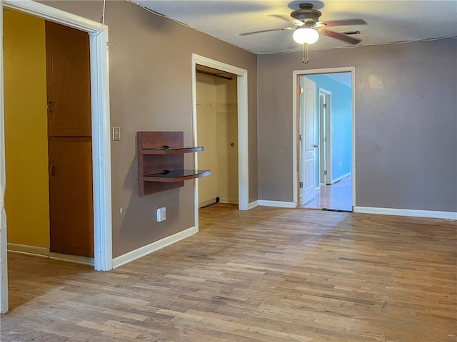 unfurnished bedroom featuring a closet, ceiling fan, and light hardwood / wood-style flooring