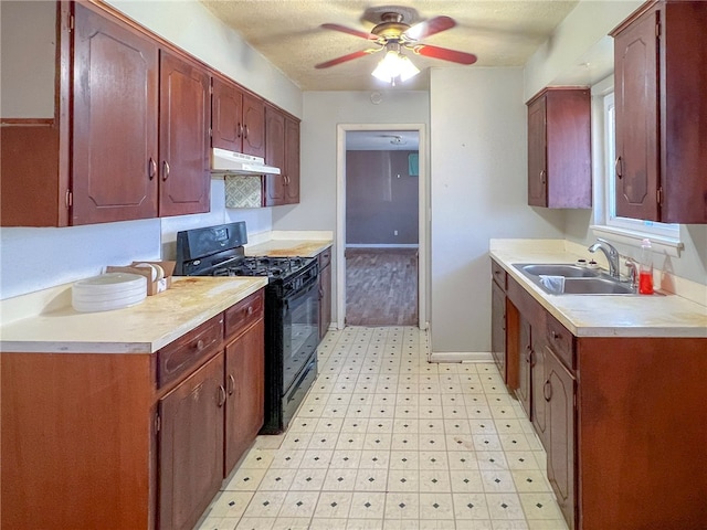 kitchen with black stove, sink, and ceiling fan