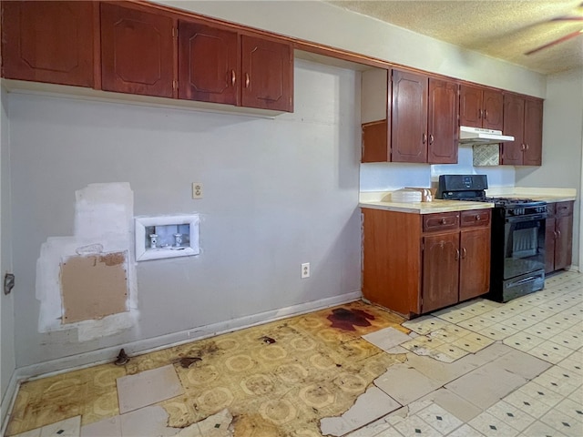 kitchen featuring a textured ceiling and black gas range