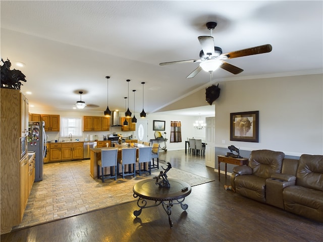 living room with sink, light hardwood / wood-style flooring, lofted ceiling, ceiling fan with notable chandelier, and ornamental molding