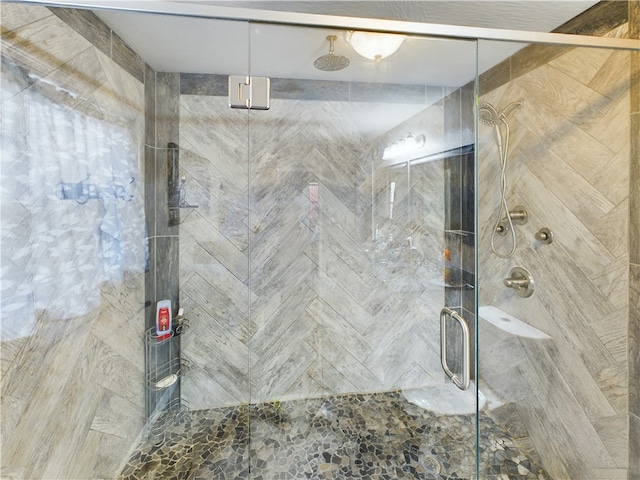 bathroom with a shower with shower door