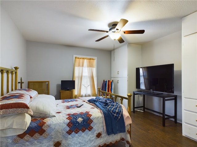 bedroom with ceiling fan and dark wood-type flooring