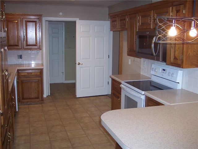 kitchen with decorative light fixtures, backsplash, and electric stove