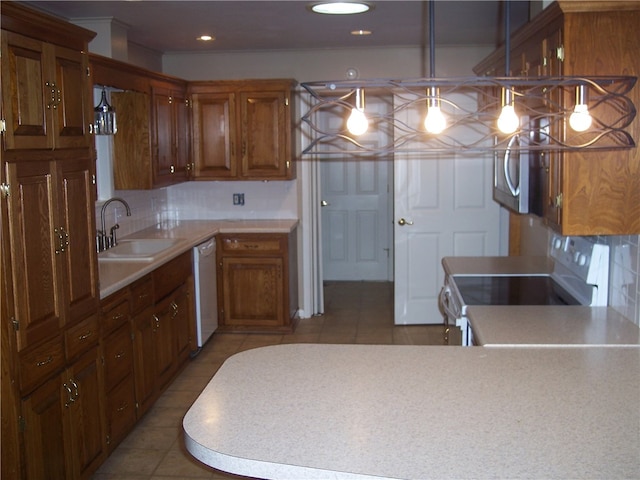 kitchen featuring sink, light tile patterned flooring, hanging light fixtures, and white appliances