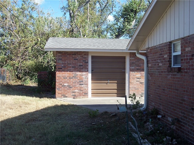 exterior space with a garage and a lawn