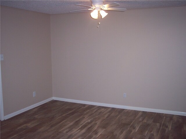 spare room featuring dark wood-type flooring, ceiling fan, and a textured ceiling