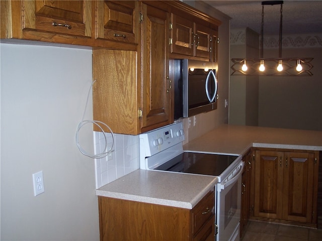 kitchen featuring decorative light fixtures, tasteful backsplash, and white electric range