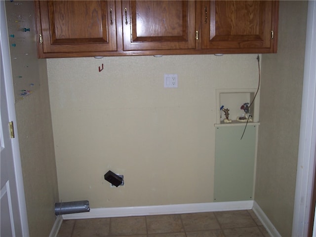 laundry room featuring cabinets, hookup for a washing machine, and light tile patterned flooring