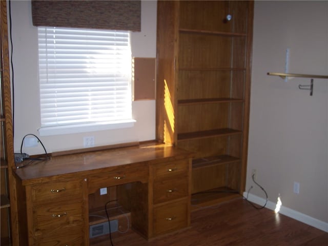 unfurnished office featuring dark hardwood / wood-style floors