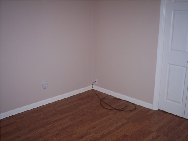 spare room featuring dark hardwood / wood-style flooring