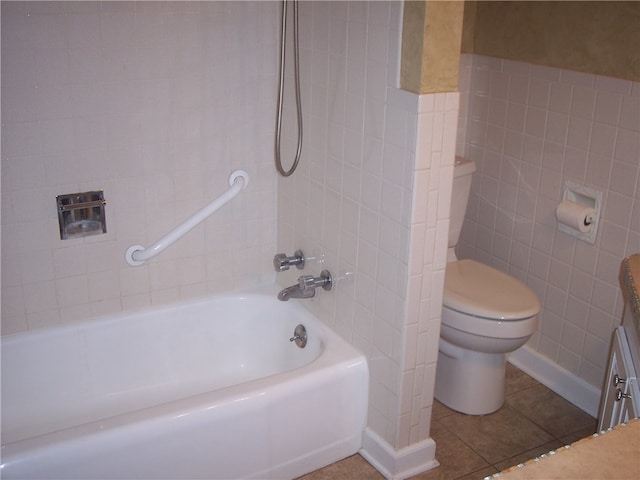 full bathroom with bathtub / shower combination, toilet, tile patterned floors, tile walls, and vanity