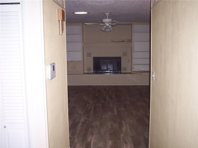 hall featuring wood-type flooring and a textured ceiling