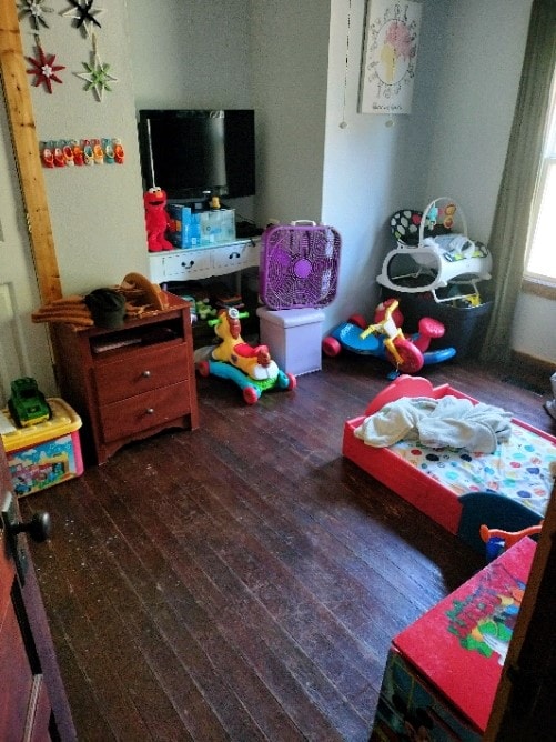 bedroom with dark wood-type flooring