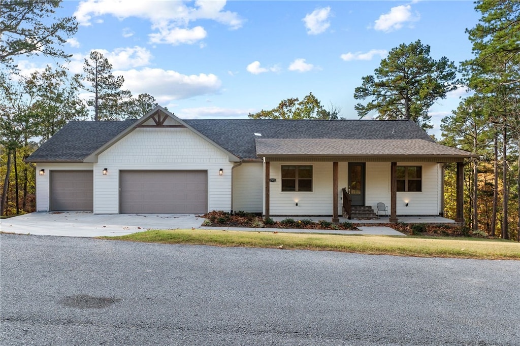 ranch-style home with covered porch and a garage