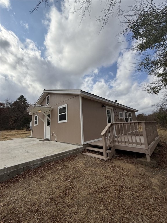 rear view of house featuring a patio area and a deck