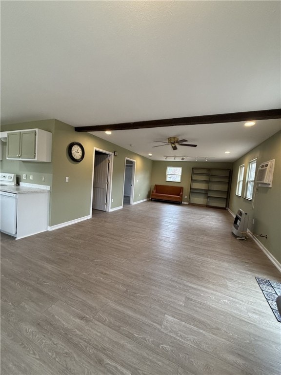 unfurnished living room with a wealth of natural light, light hardwood / wood-style flooring, and ceiling fan