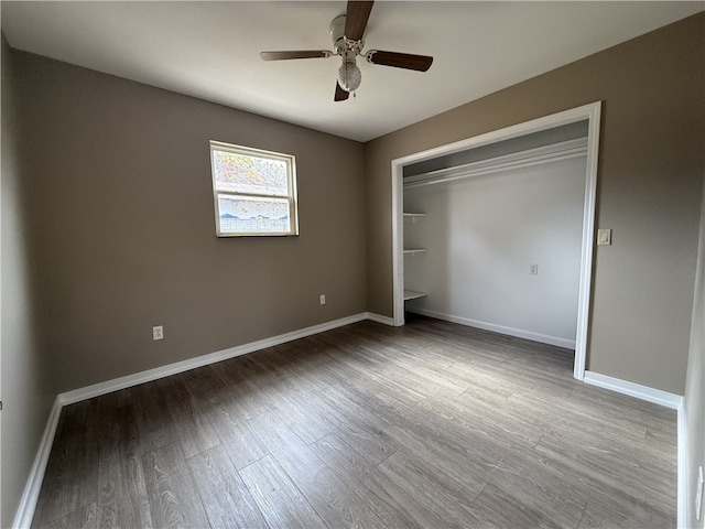 unfurnished bedroom with a closet, hardwood / wood-style floors, and ceiling fan