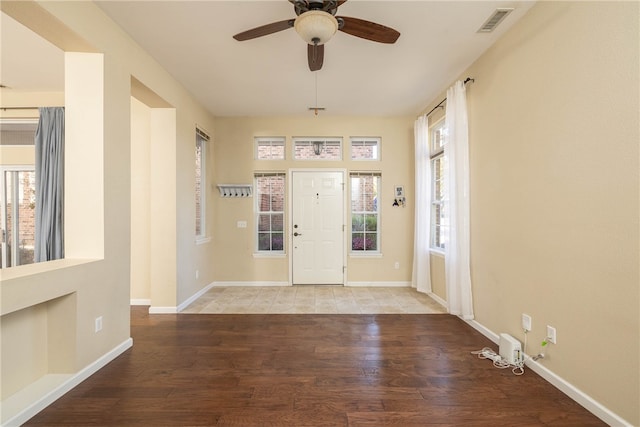 foyer entrance featuring hardwood / wood-style floors, ceiling fan, and a healthy amount of sunlight