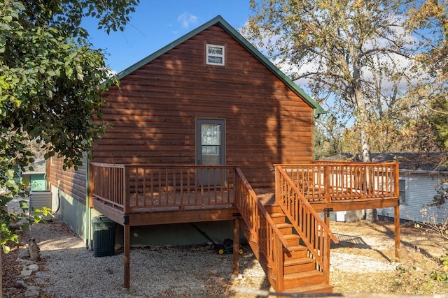 back of property with central AC and a deck