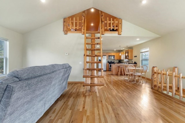 living room with vaulted ceiling, recessed lighting, light wood-style flooring, and baseboards