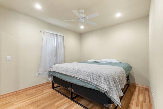 bedroom with wood-type flooring and ceiling fan