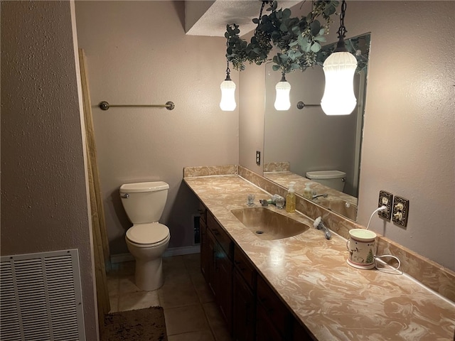 bathroom with vanity, tile patterned floors, and toilet