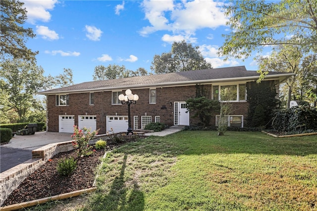 raised ranch with a front yard and a garage