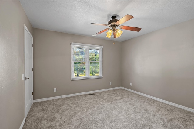 empty room featuring light carpet, a textured ceiling, and ceiling fan