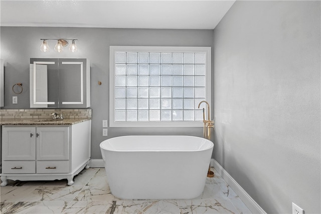 bathroom with vanity and a washtub