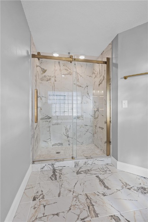 bathroom with a shower with shower door