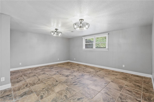 unfurnished room featuring a textured ceiling and an inviting chandelier