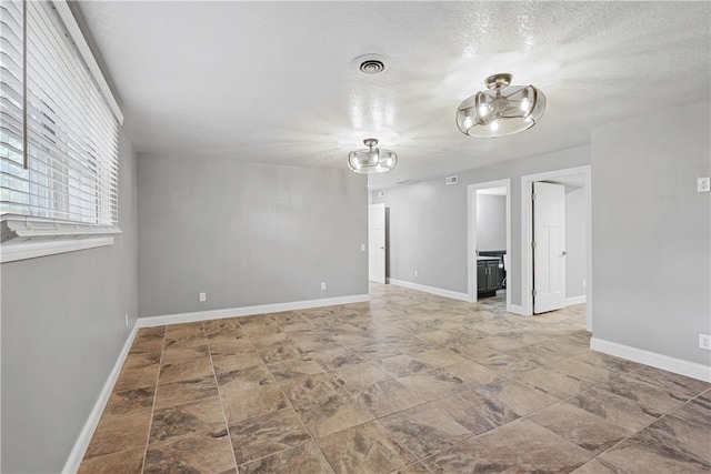 spare room with a textured ceiling