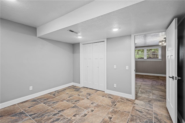 unfurnished bedroom featuring a closet and a textured ceiling