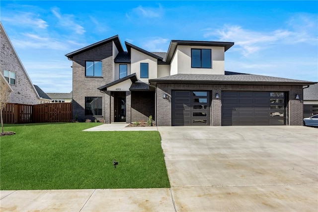 view of front of home featuring a front lawn and a garage