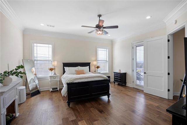 bedroom featuring dark wood-type flooring, ceiling fan, multiple windows, and access to exterior