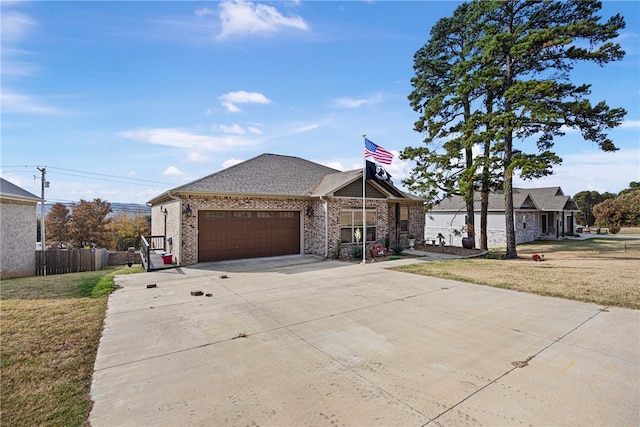 view of front of house featuring a front lawn and a garage