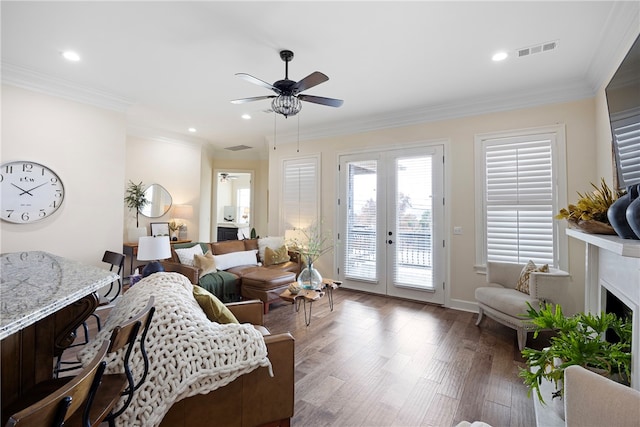 living room with ornamental molding, french doors, dark hardwood / wood-style floors, and ceiling fan