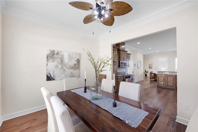 dining room with ceiling fan, ornamental molding, and dark hardwood / wood-style floors