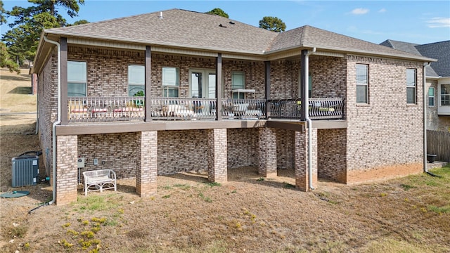 rear view of house with central AC unit