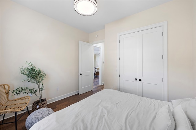 bedroom with a closet and dark hardwood / wood-style floors