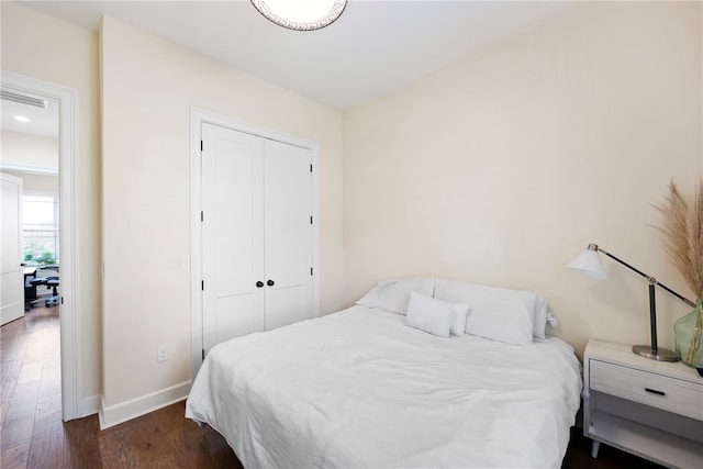 bedroom featuring a closet and dark hardwood / wood-style floors