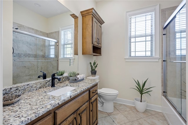 full bathroom with toilet, combined bath / shower with glass door, vanity, and tile patterned flooring