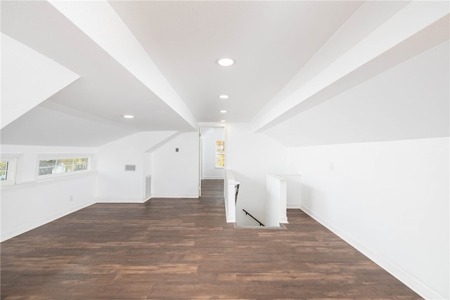 additional living space with lofted ceiling and dark hardwood / wood-style flooring