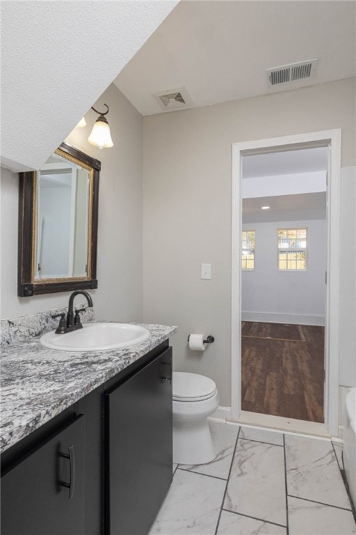 bathroom featuring vanity and toilet