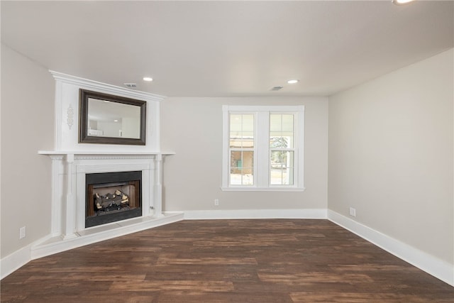 unfurnished living room with dark hardwood / wood-style flooring