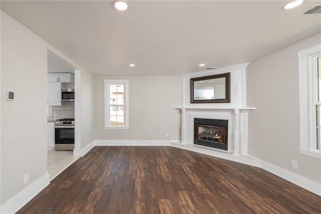 unfurnished living room featuring light hardwood / wood-style floors